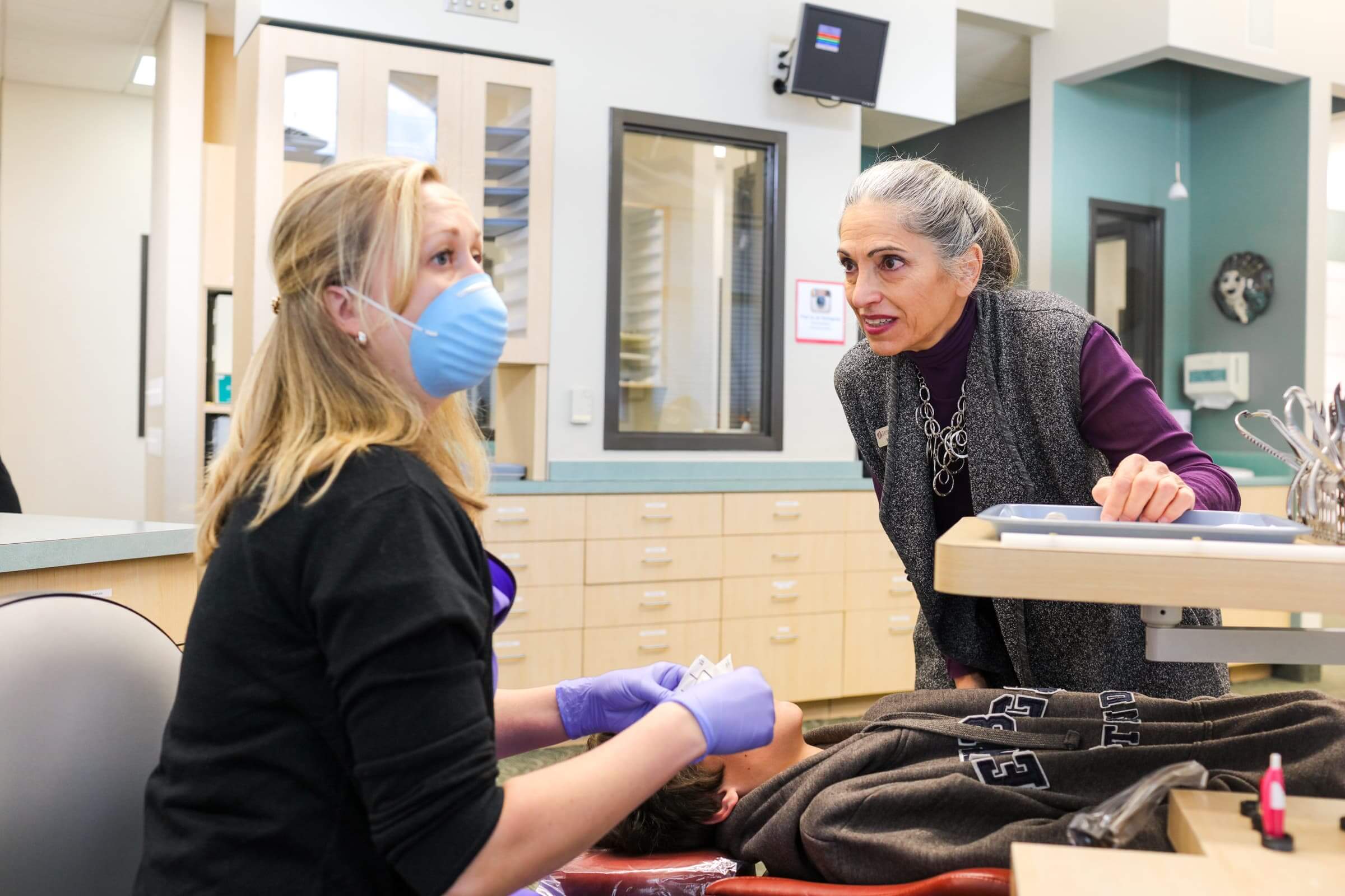 Assistant working on patient