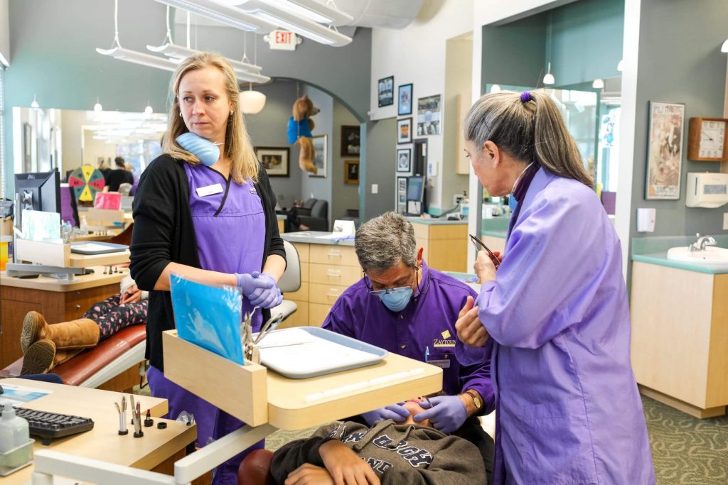 Doctor and assistants working on patient