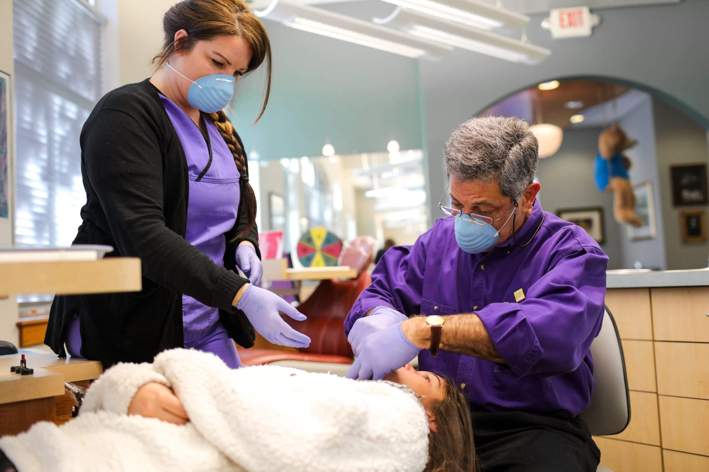 Doctor and assistant working on patient