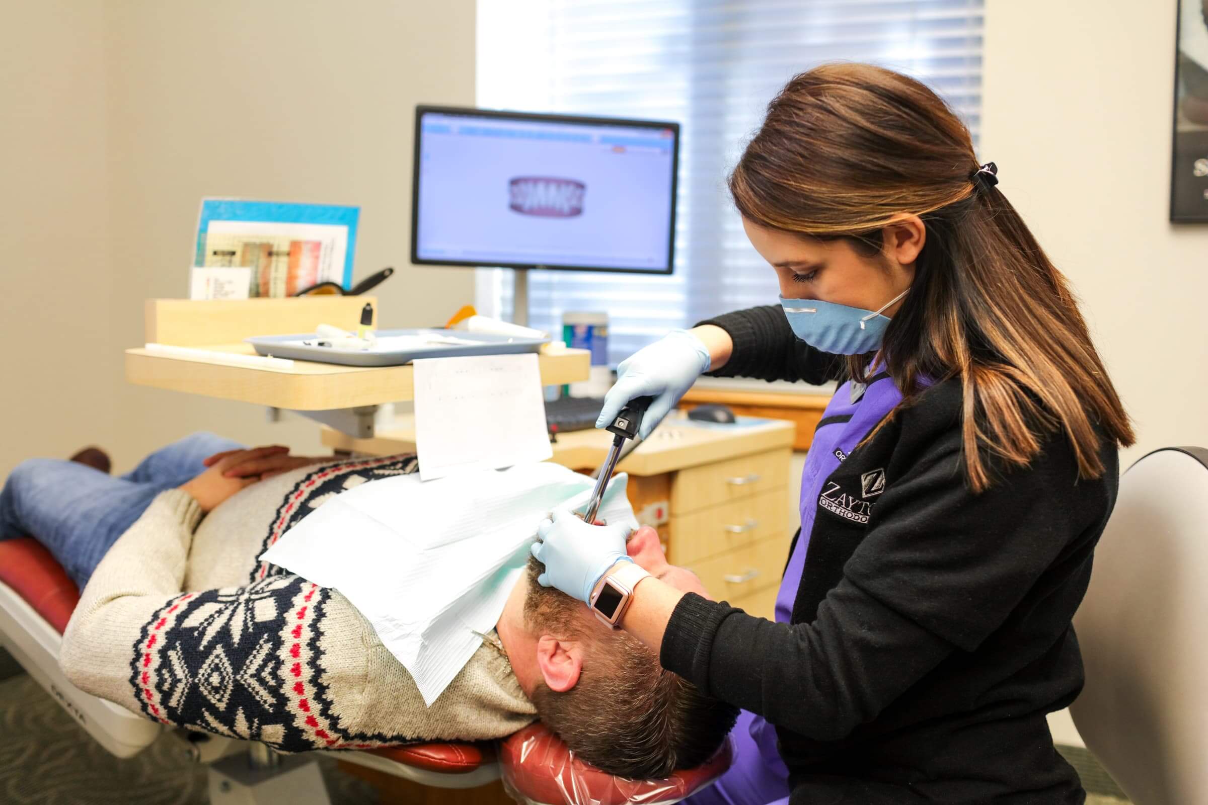 Assistant working on patient